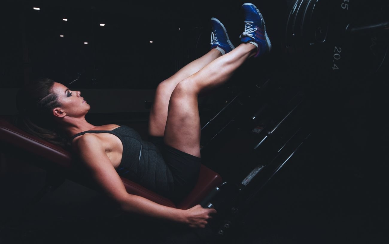 Get Past A Fitness Or Workout Plateau With Our 6 Helpful Tips 7 A person a an inverted squat machine.