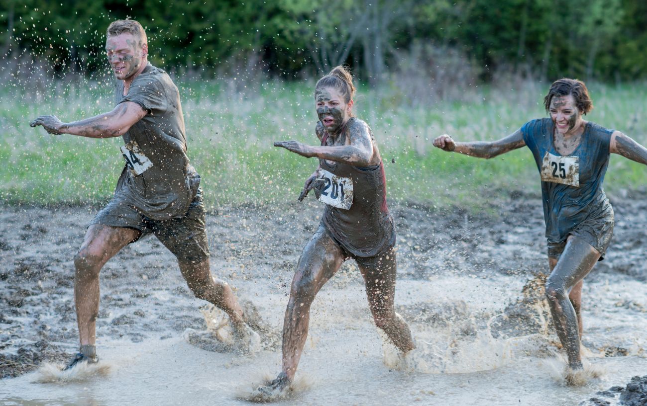 people running in mud