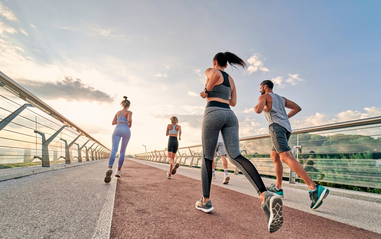 runners crossing a bridge