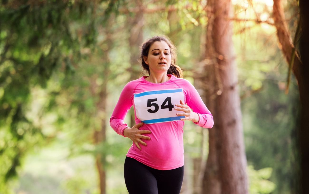 Una mujer embarazada corriendo.