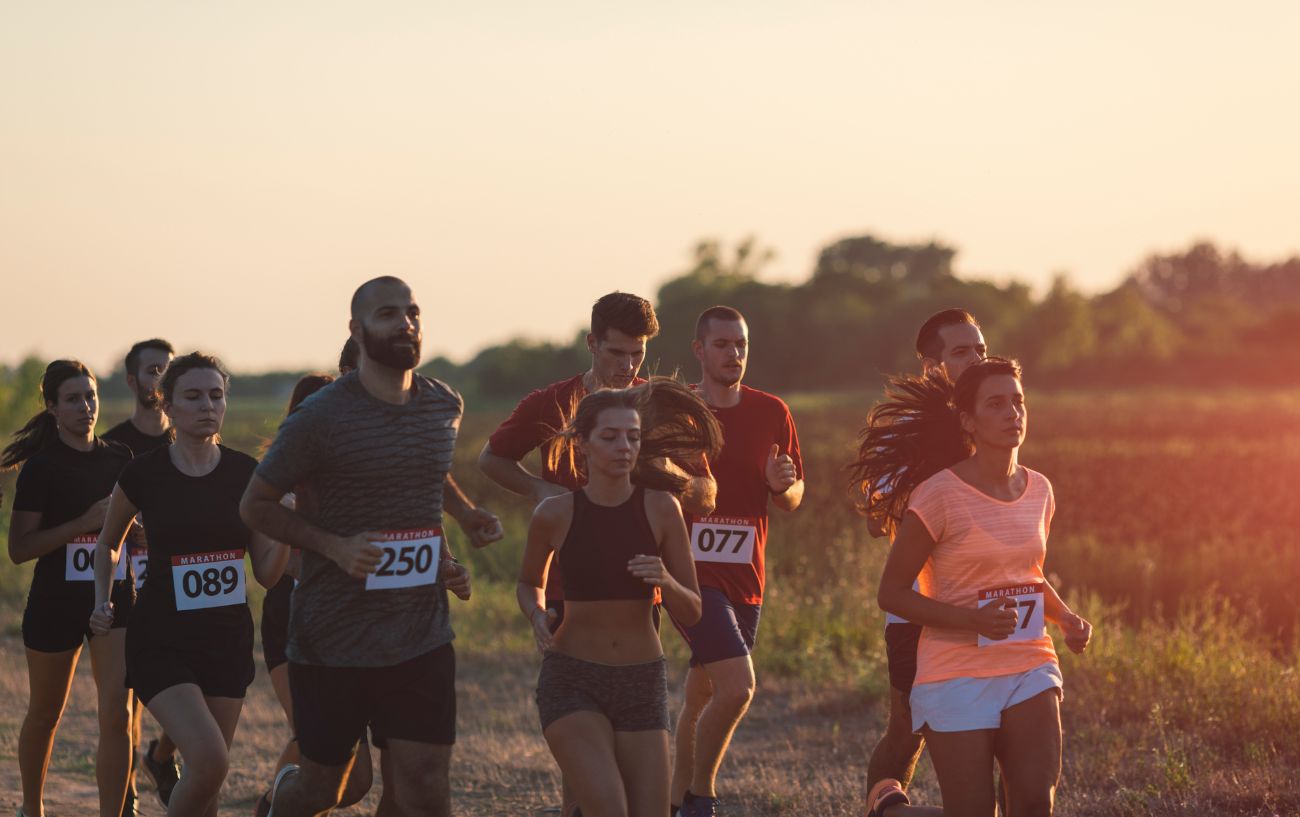 a group of runners on a dusty trail