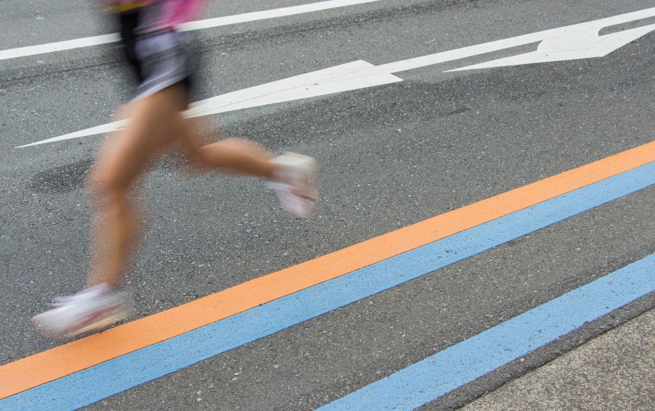 A female runner's legs on a road