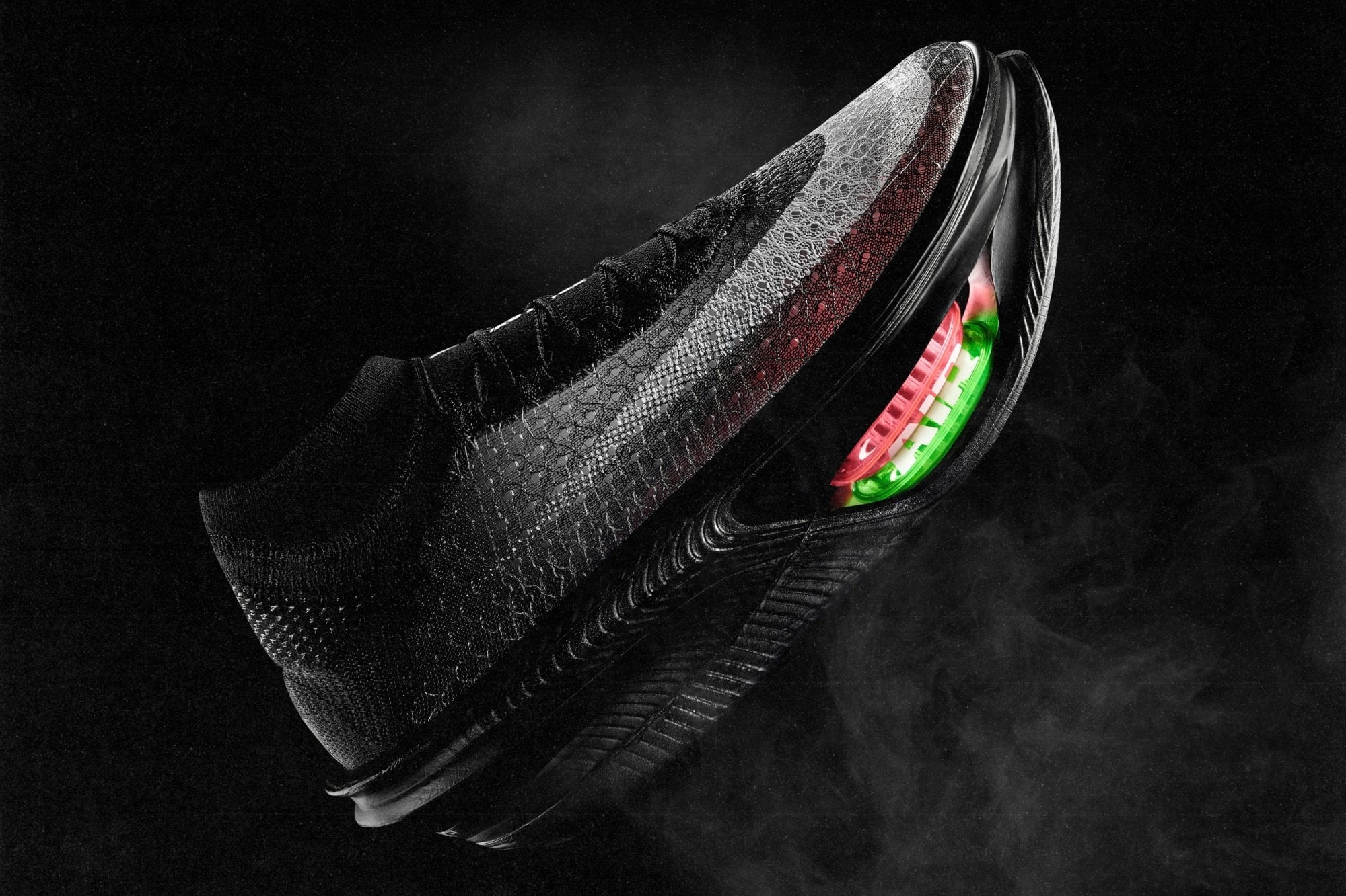 The black Nike Apex racing shoe seen from the lateral side, with a window in the forefoot midsole showing stacked Air Zoom units