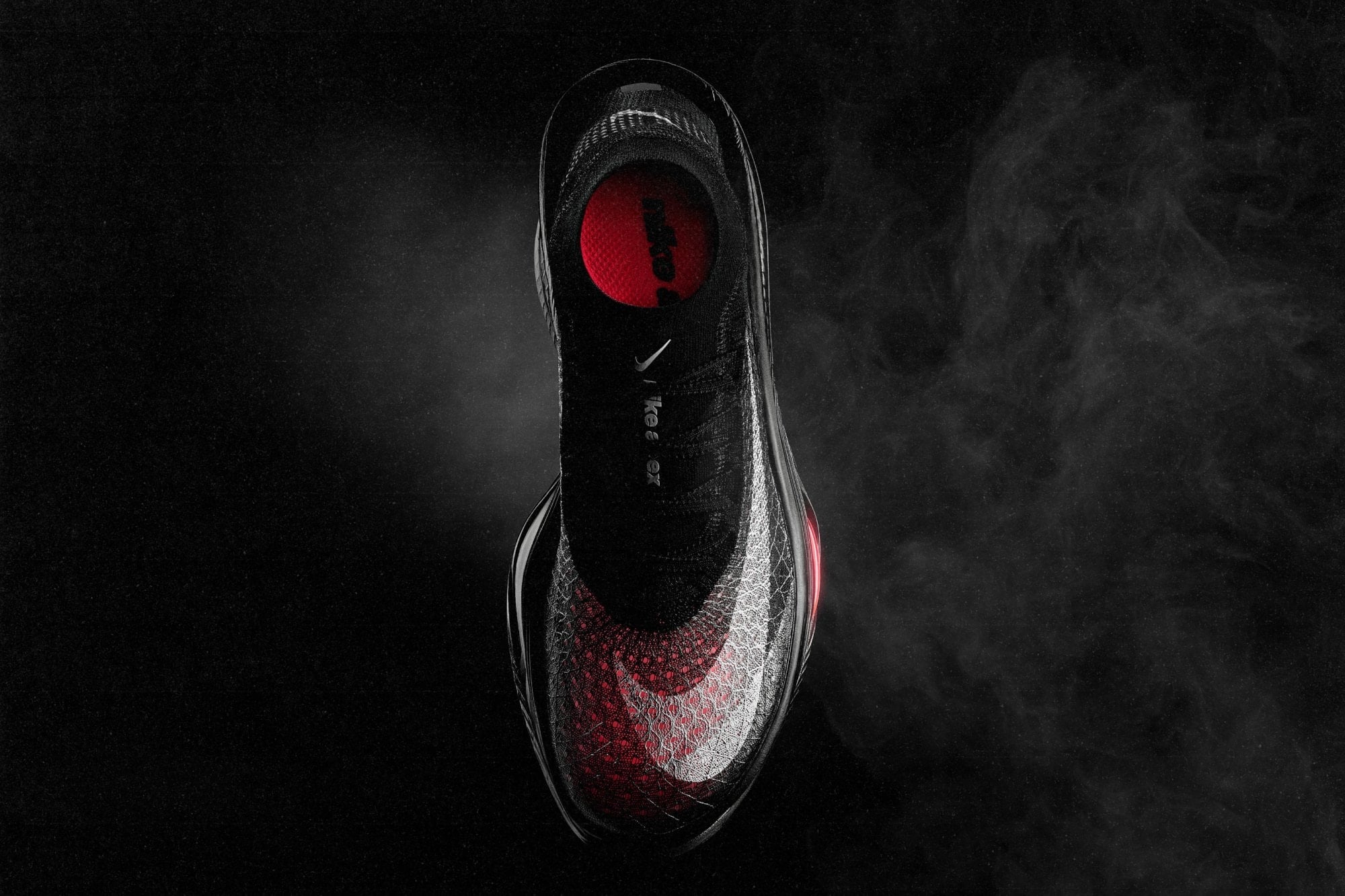 Overhead view of the Nike Apex showing its black and white Flyknit X upper over a red underlay and a knit collar
