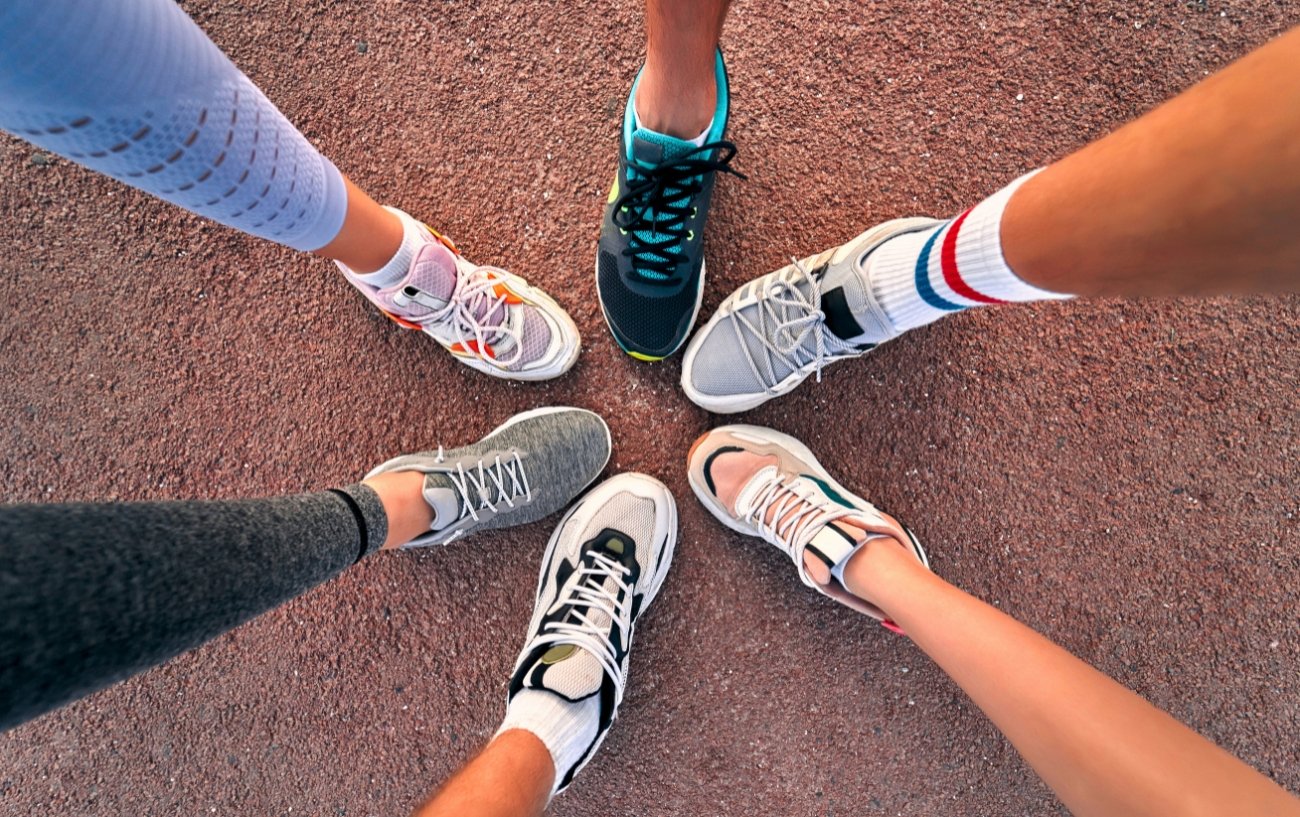 People joining running shoes in a circle